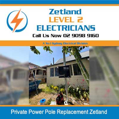 Electricians working on residential private power pole with elevated work platform in Zetland